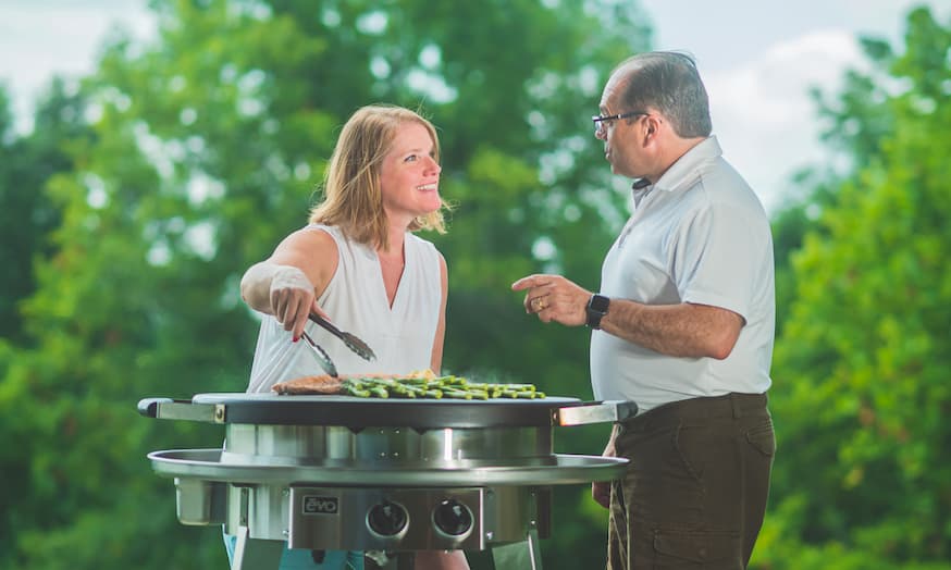 Chef Jeff seasoning skewers on the grill